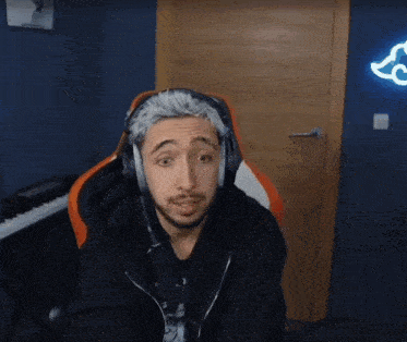 a man wearing headphones is sitting in front of a piano