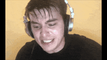 a man wearing headphones and making a funny face