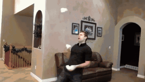 a man in a black shirt is throwing a frisbee in the air