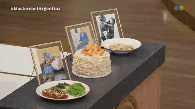 a table with plates of food and a picture of a family with #masterchefargentina written above it