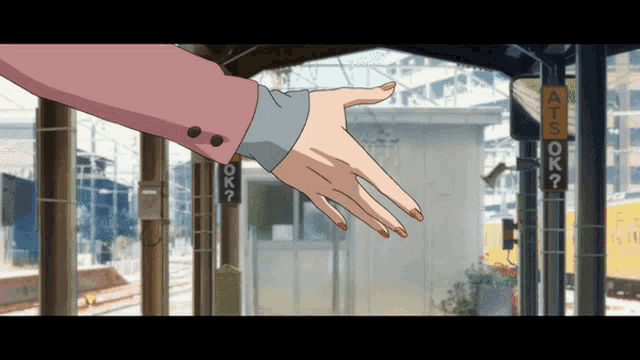 a woman 's hand is reaching out towards a sign that says " ok "