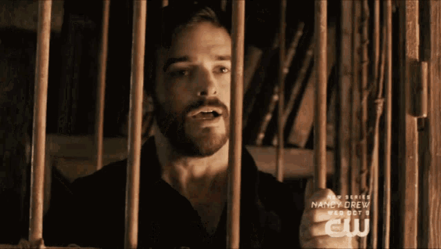 a man behind bars with the words nancy drew on the bottom right