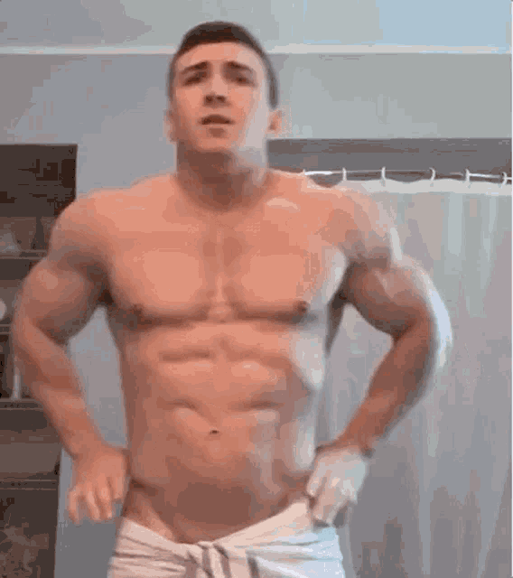 a shirtless man is wrapped in a white towel