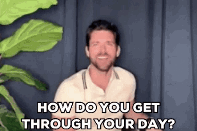 a man is standing in front of a plant and asking how do you get through your day .