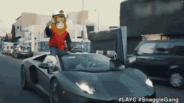 a man in a captain 's hat is driving a car with the caption #layc snagglegang