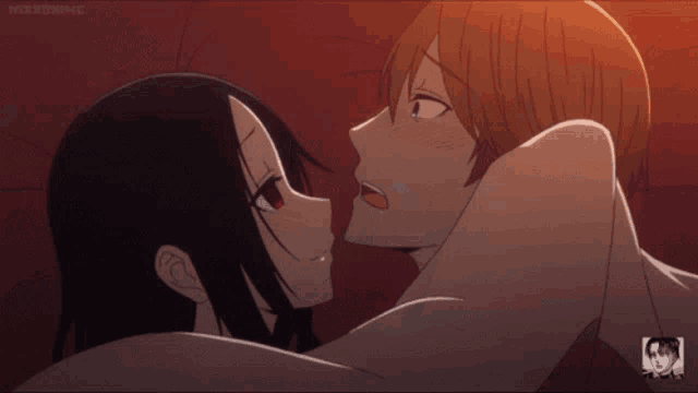 a man and a woman are kissing in a dark room