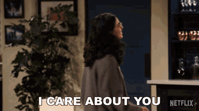 a woman says " i care about you " in a living room