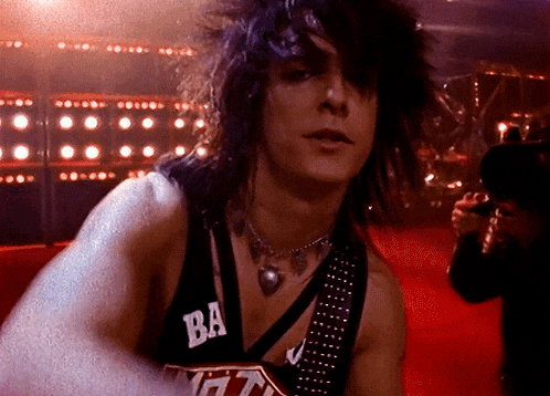 a man wearing a black tank top with ba on the front