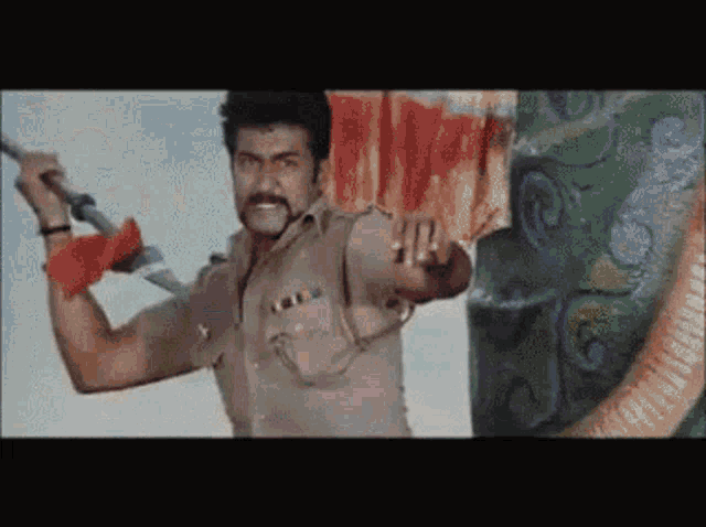 a man in a police uniform is holding a sword and pointing at the camera