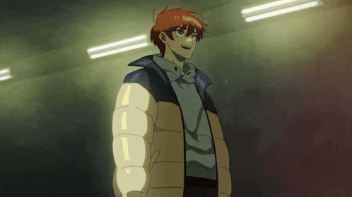 a man with red hair is wearing a jacket with the letter i on the sleeve