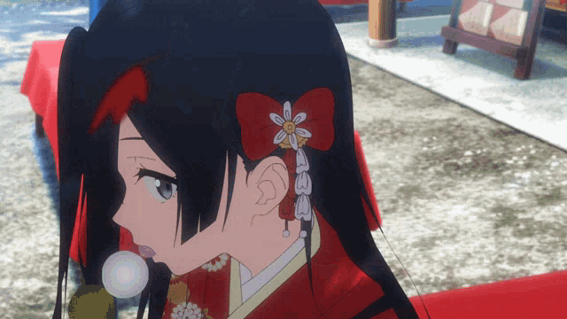 a girl with black hair and a red bow on her hair