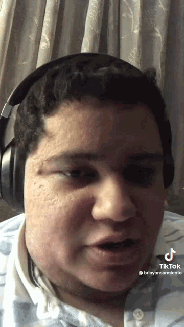 a man wearing headphones has tiktok written on the bottom right