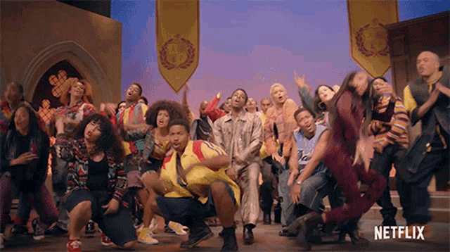 a group of people are dancing in front of a banner that says netflix on it