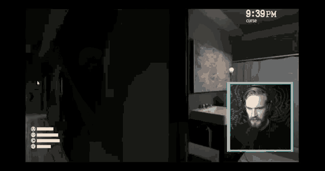 a man with a beard is playing a video game with a scary face in the background .
