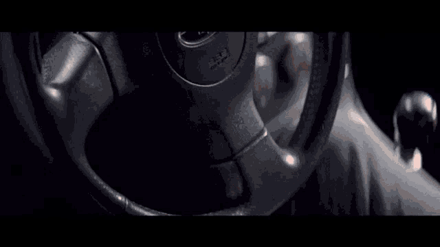 a close up of a person 's hand on a steering wheel with the word airbag on it