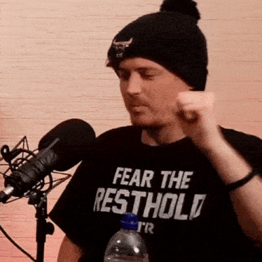 a man wearing a t-shirt that says fear the resthold