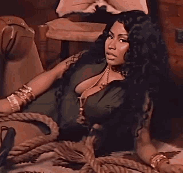 a woman is laying on the floor with a rope around her
