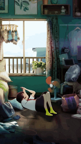 a girl is laying on the floor in a messy room with a fan
