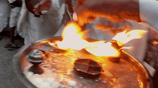 a person is lighting a fire on a tray