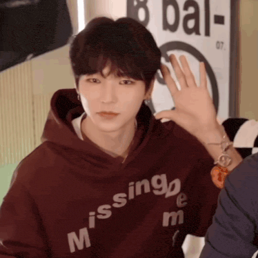 a person wearing a hoodie that says missing me on it