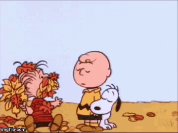 a cartoon of charlie brown and snoopy eating leaves .