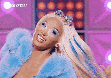 a woman wearing a blue fur coat is smiling and the word crystali is on the bottom