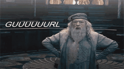 a man with a beard stands with his hands on his hips in front of a sign that says guuuuuuuurl