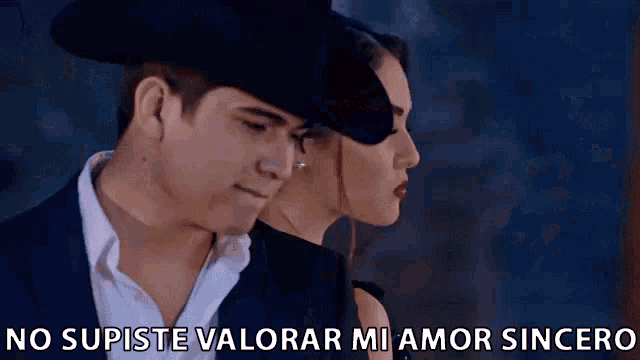 a man and a woman are standing next to each other with the words no supiste valorar mi amor sincero written below them .