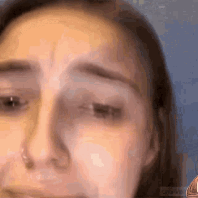 a close up of a woman 's face with tears running down her face