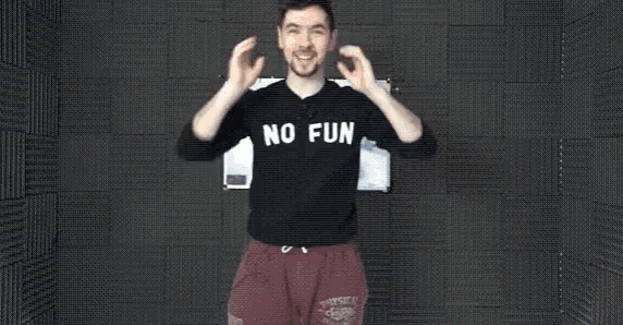 a man covering his ears with his hands wearing a sweater that says nl cun