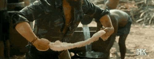a man with a beard is holding a long piece of rope .