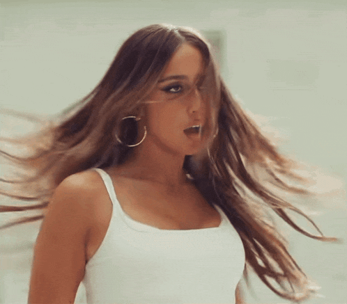 a woman with long hair wearing hoop earrings