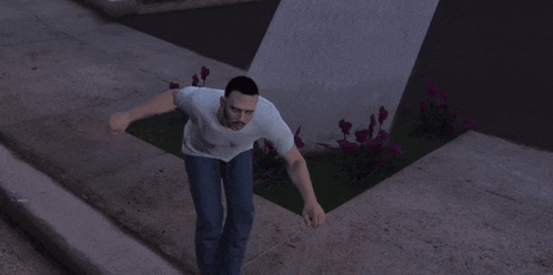 a man in a white t-shirt and blue jeans is running