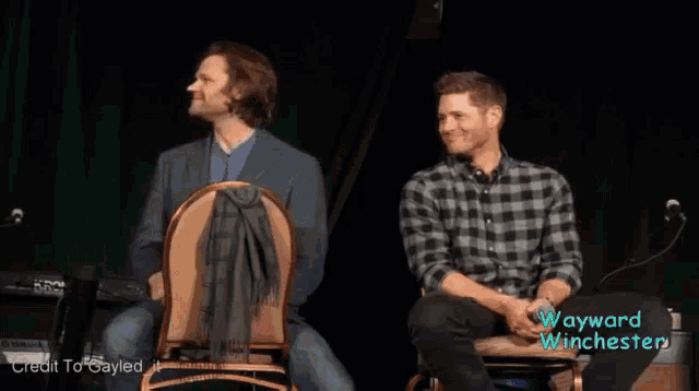 two men on a stage with a sign that says wayward winchester on it