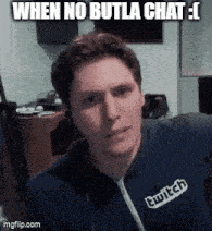 a man wearing a sweatshirt that says twitch looks at the camera