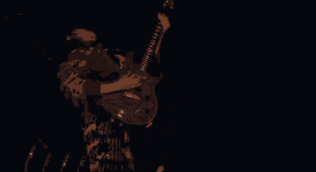 a man is playing a guitar in a dark room with a blue light behind him