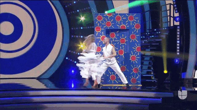 a man and a woman dancing on a stage