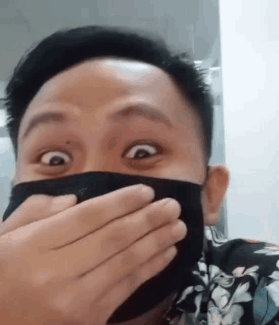 a man wearing a black mask is making a funny face