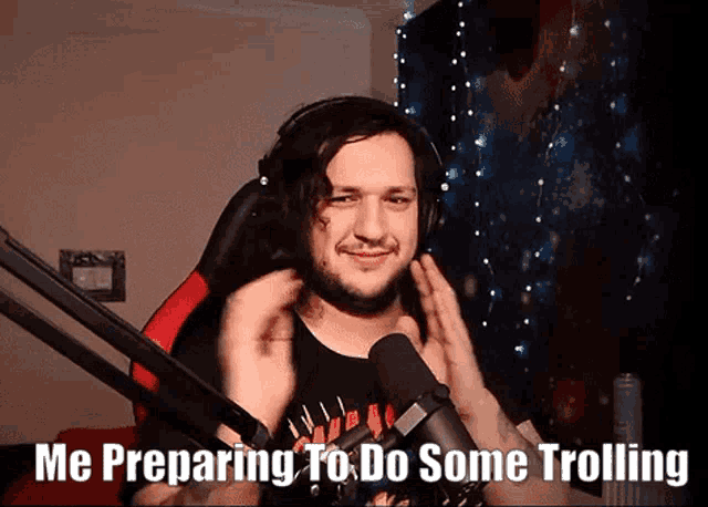 a man wearing headphones and a shirt that says ' me preparing to do some trolling ' on it