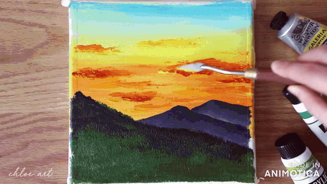 a painting of a sunset is being created by chloe