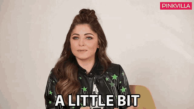 a woman in a leather jacket is sitting in a chair and says a little bit