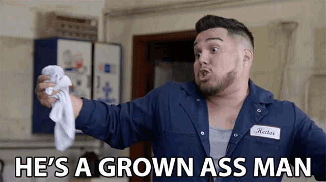 a man holding a towel with the words he 's a grown ass man below him