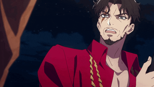 a man with a beard wearing a red shirt and gold chains