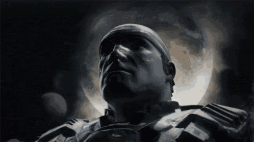 a close up of a man 's face in front of a full moon in a dark room .