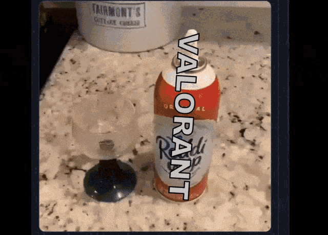 a bottle of valorant sits next to a wine glass