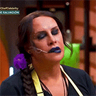 a woman with blue lipstick and a braid is wearing a headset on her face .