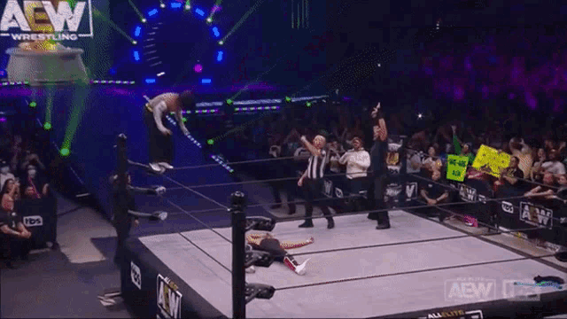 a wrestler in a ring with a sign that says we are all