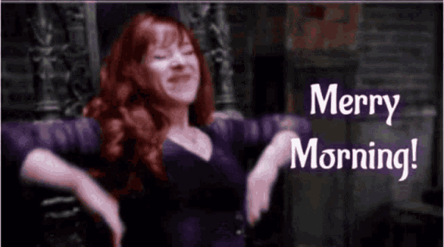 a woman with red hair is dancing in front of a sign that says merry morning !