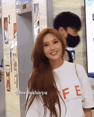a woman wearing a white shirt that says fe