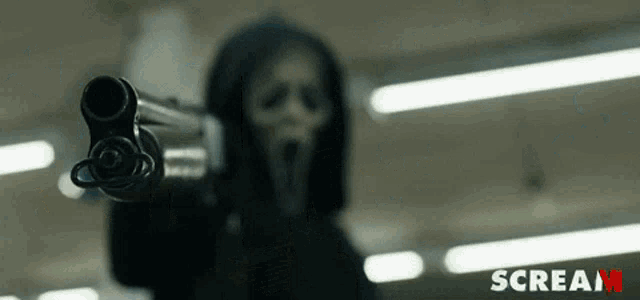 a person in a scream mask is pointing a shotgun at the camera